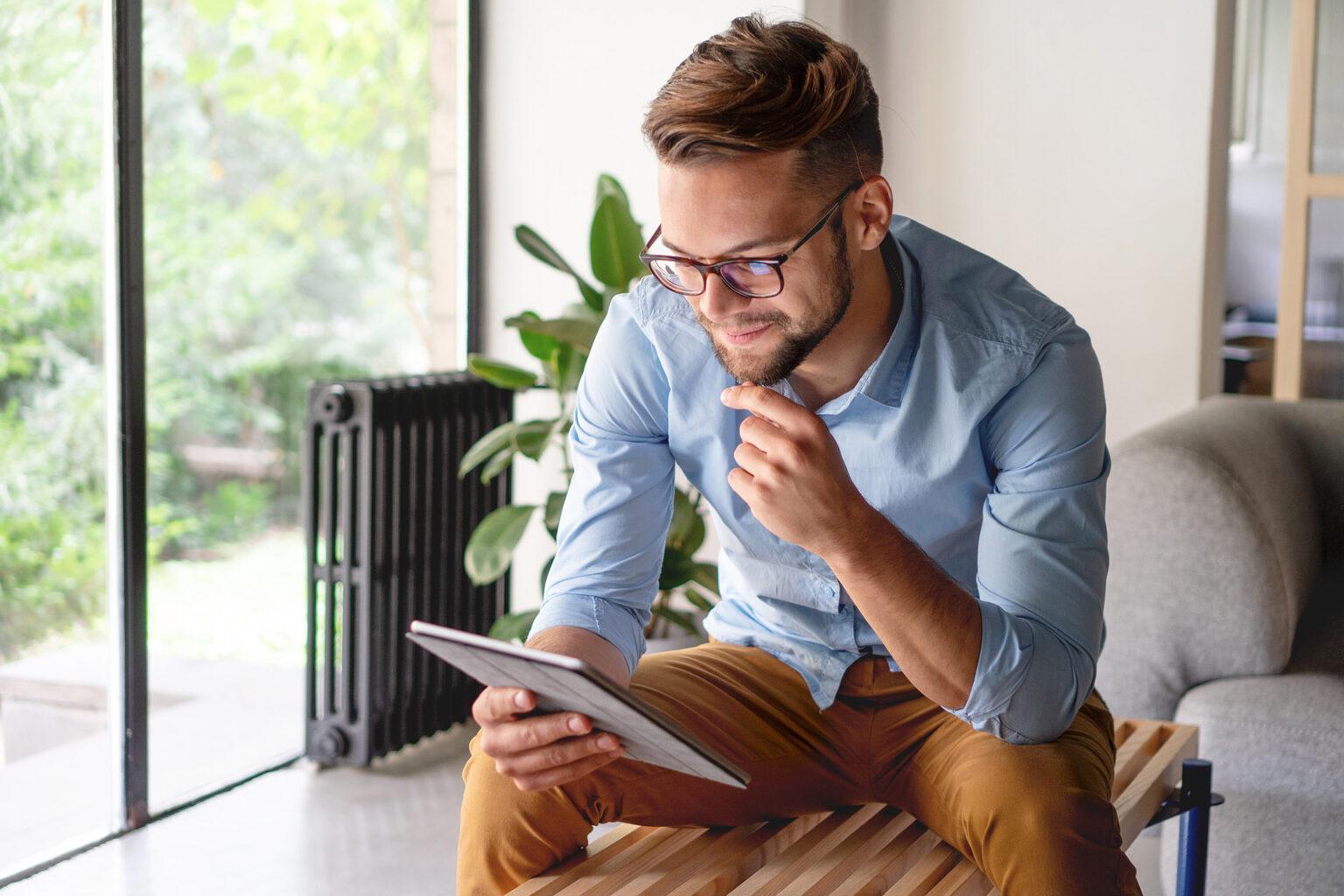 young man looking for jobs on ipad